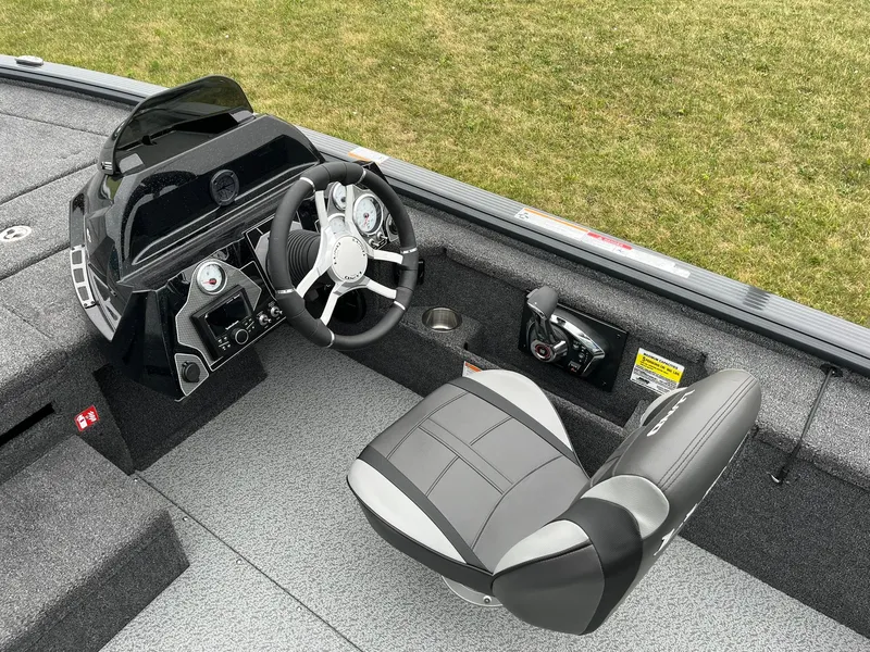 Slide: The Image of 2026 Lund 2075 Pro-V Bass XS boat interior with steering console and seat. - 11