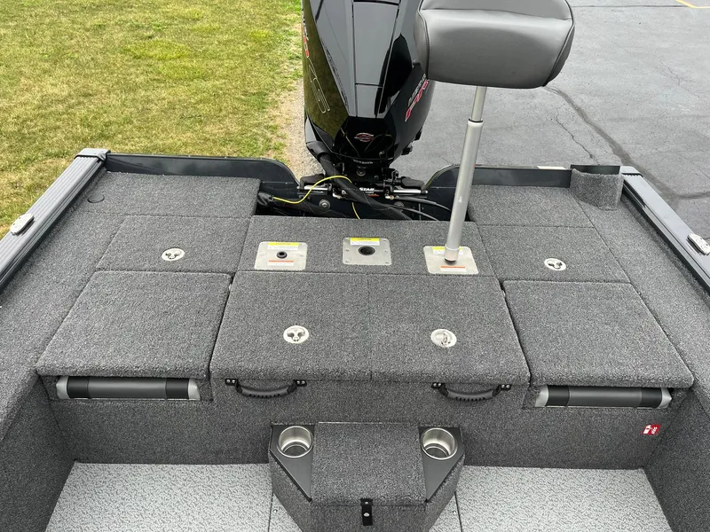 Slide: The Image of 2026 Lund 2075 Pro-V Bass XS boat interior with gray carpet and seating. - 14