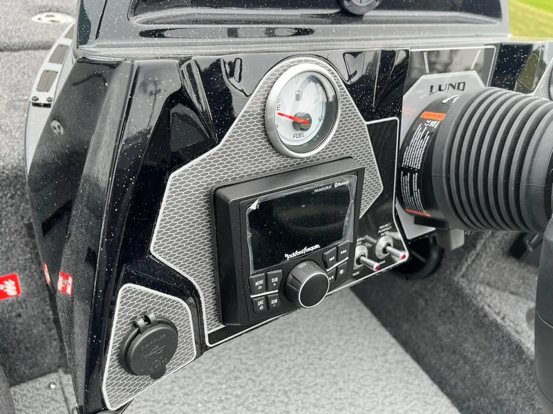 Slide: The Image of Dashboard of 2026 Lund 2075 Pro-V Bass XS boat with fuel gauge and controls. - 16