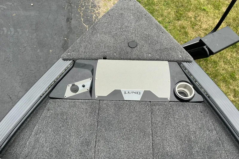 Slide: The Image of 2026 Lund 2075 Pro-V Bass XS boat deck with control panel and cup holder. - 20