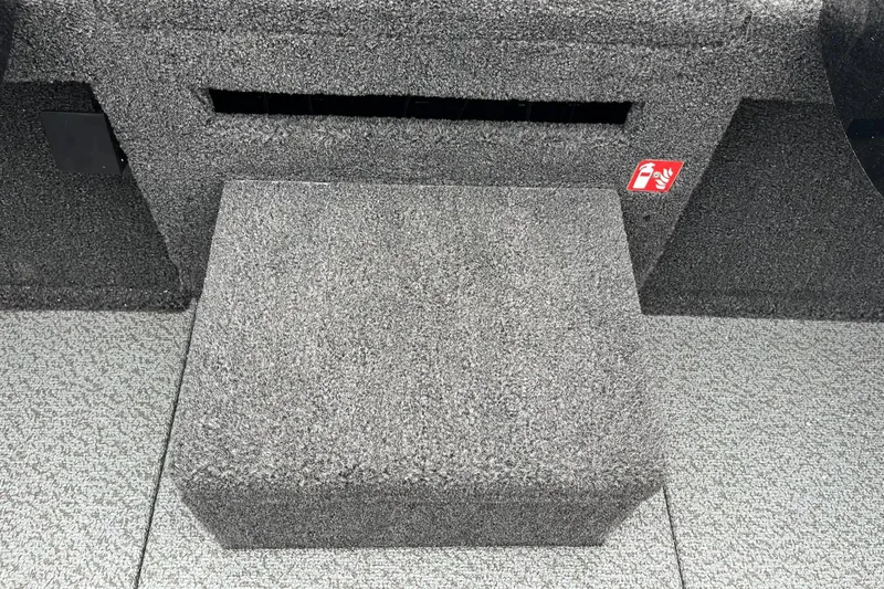 Slide: The Image of Carpeted interior of 2026 Lund 2075 Pro-V Bass XS boat, featuring a step and storage area. - 21