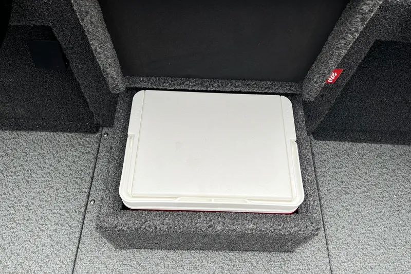 Slide: The Image of 2026 Lund 2075 Pro-V Bass XS boat storage compartment with white cooler. - 22