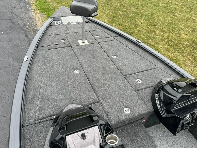 Slide: The Image of 2026 Lund 2075 Pro-V Bass XS boat deck with seating and storage compartments. - 8