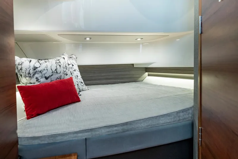 Slide: The Image of Manufacturer Provided Image: 2023 Tiara Yachts 34 LS cabin interior with bed, pillows, and modern lighting. - 10