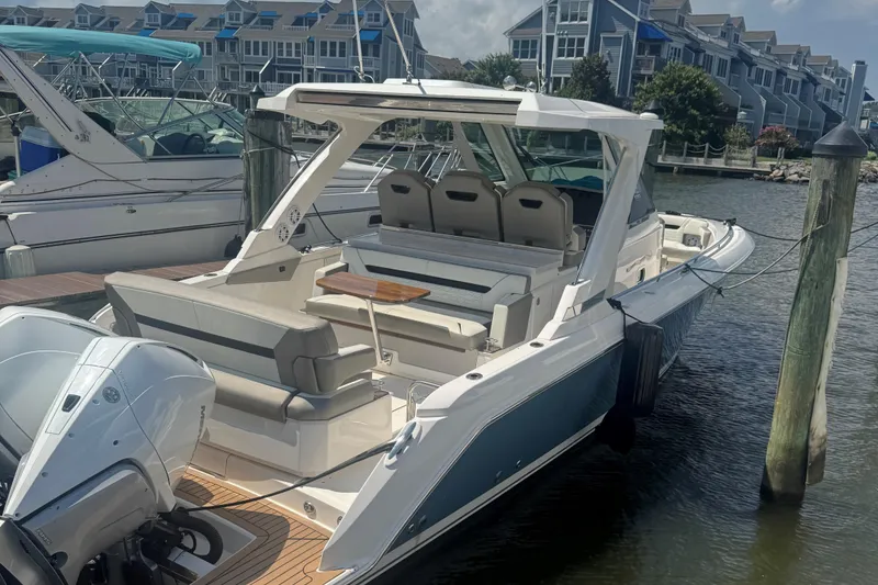 Slide: The Image of 2023 Tiara Yachts 34 LS docked at marina, showcasing sleek design and luxury features. - 2