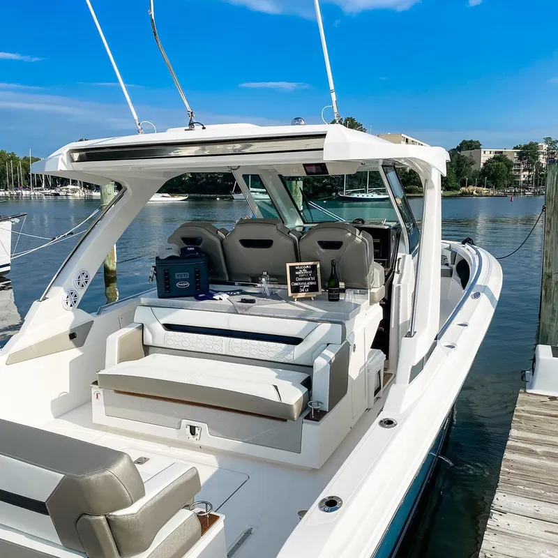 Slide: The Image of 2023 Tiara Yachts 34 LS luxury boat docked by the water. - 3