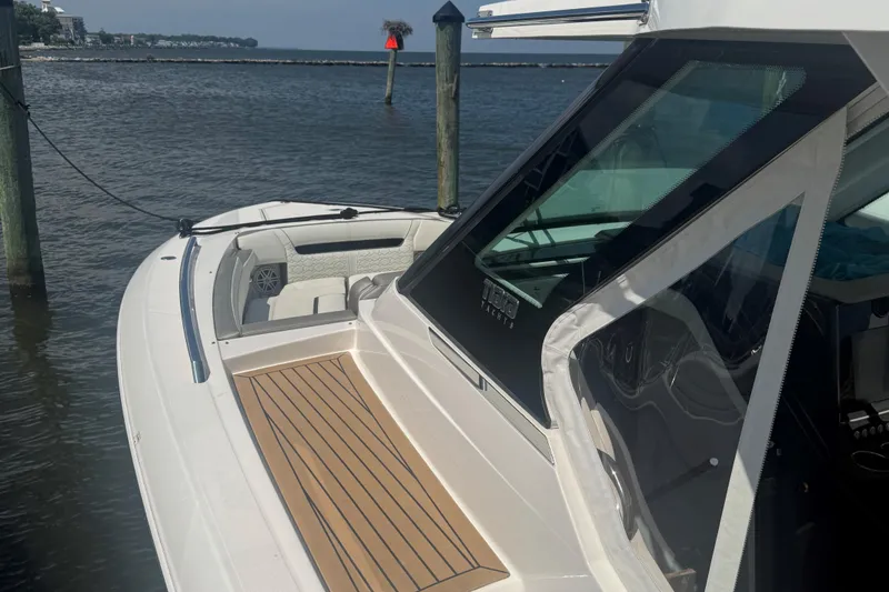 Slide: The Image of 2023 Tiara Yachts 34 LS docked, showcasing sleek design and spacious deck. - 4