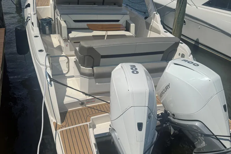 Slide: The Image of 2023 Tiara Yachts 34 LS with dual Mercury outboard engines, docked at a marina. - 5