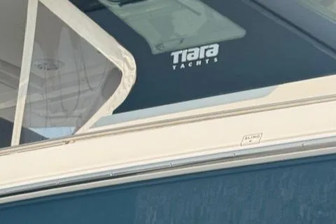 Slide: The Image of 2023 Tiara Yachts 34 LS, close-up of logo and window detail. - 7