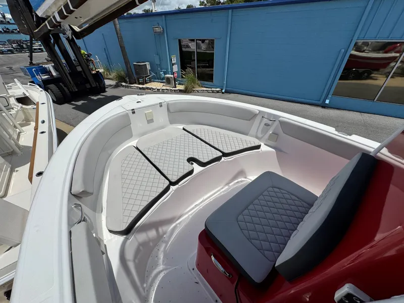 Slide: The Image of 2023 Clearwater 2200 boat interior with cushioned seating and modern design. - 10