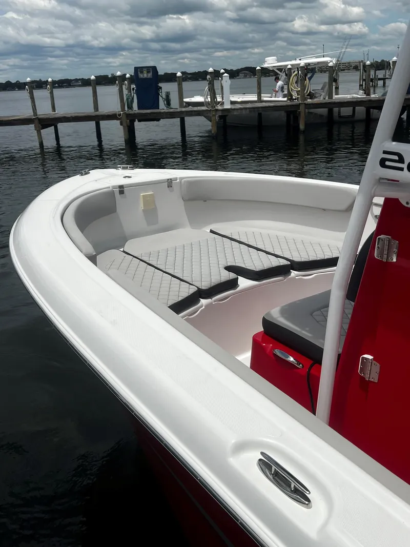 Slide: The Image of 2023 Clearwater 2200 boat docked, featuring spacious seating and sleek design. - 7