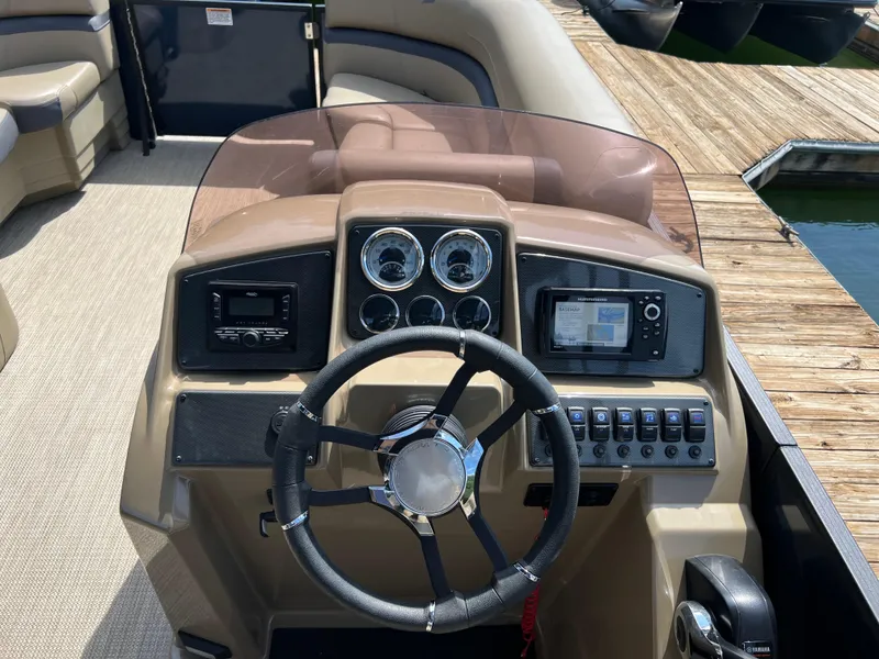 Slide: The Image of Steering console of 2025 Starcraft EXS 3 boat with gauges and controls. - 10