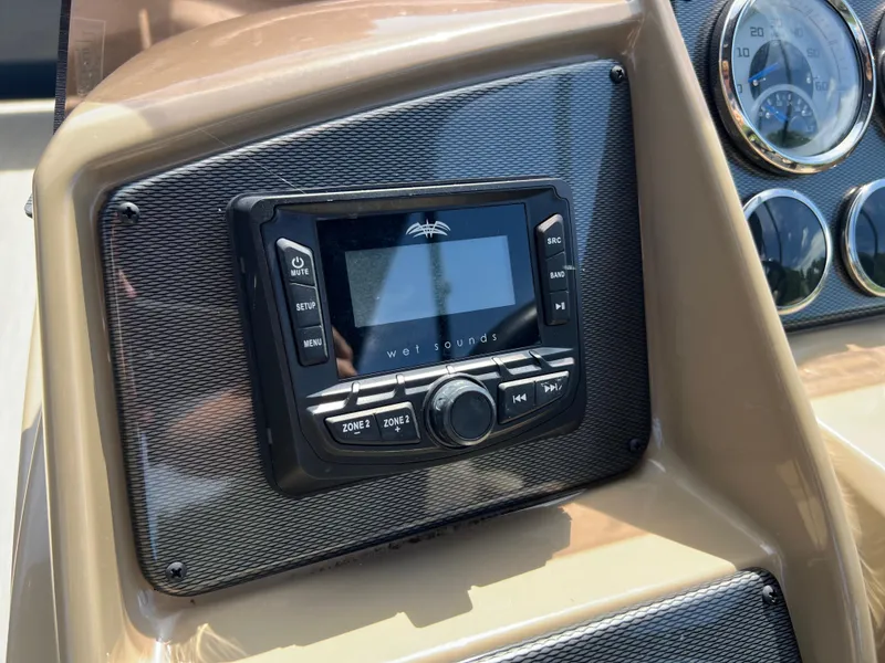 Slide: The Image of 2025 Starcraft EXS 3 dashboard featuring Wet Sounds audio system and gauges. - 11