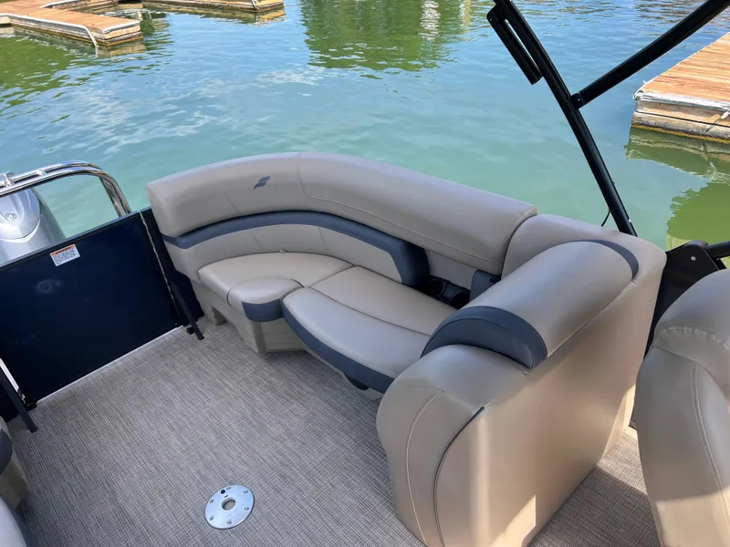 Slide: The Image of Luxurious seating on 2025 Starcraft EXS 3 boat, docked on calm water. - 15