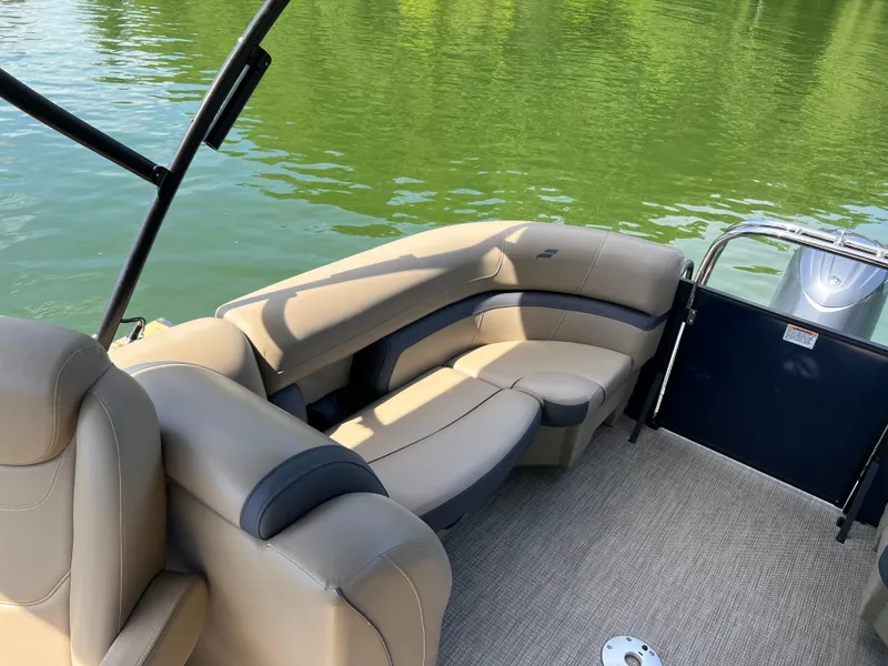 Slide: The Image of 2025 Starcraft EXS 3 boat interior with beige seating on a calm lake. - 16