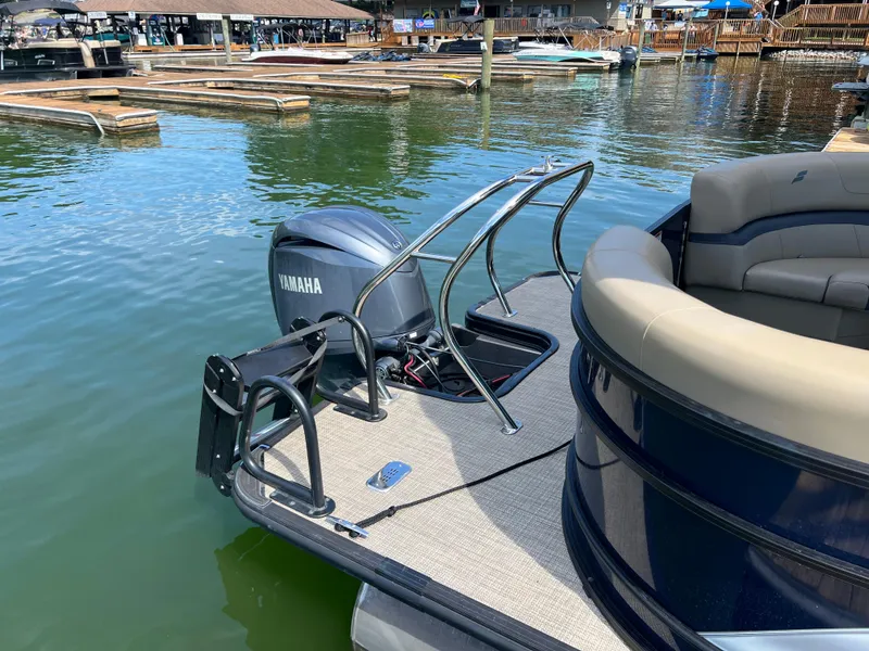 Slide: The Image of 2025 Starcraft EXS 3 pontoon boat with Yamaha motor at marina dock. - 4