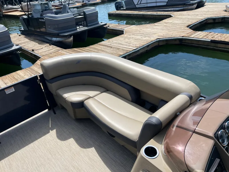 Slide: The Image of Luxurious seating on a 2025 Starcraft EXS 3 pontoon boat at a marina dock. - 6