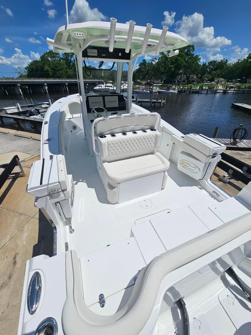 Slide: The Image of 2026 Sea Hunt Ultra 275 SE boat docked, featuring spacious seating and modern design. - 11
