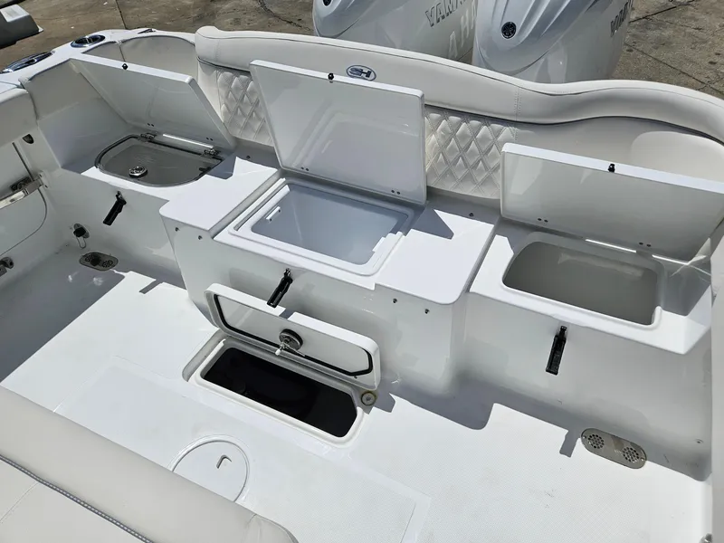 Slide: The Image of 2026 Sea Hunt Ultra 275 SE boat interior with open storage compartments and seating. - 13