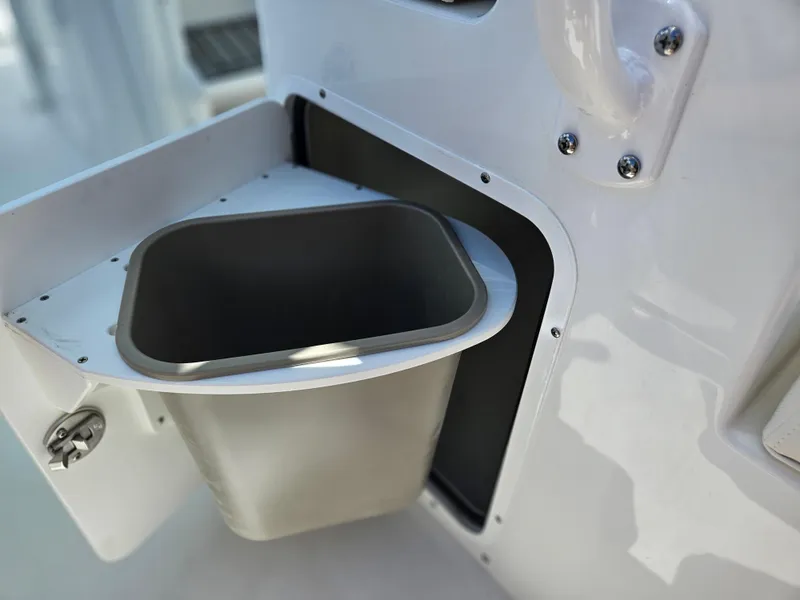 Slide: The Image of Built-in trash compartment on 2026 Sea Hunt Ultra 275 SE boat. - 17