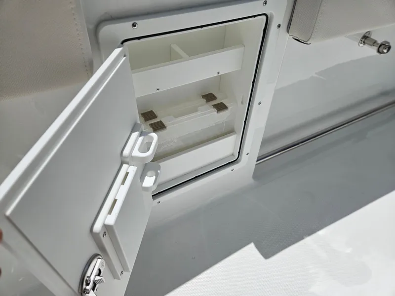 Slide: The Image of Open storage compartment on 2026 Sea Hunt Ultra 275 SE boat. - 19