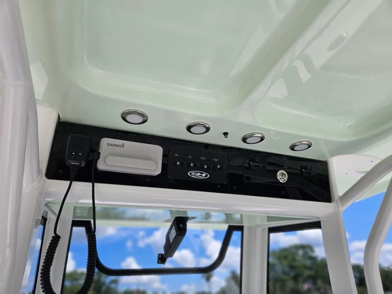 Slide: The Image of 2026 Sea Hunt Ultra 275 SE boat console with Garmin equipment and overhead lighting. - 25