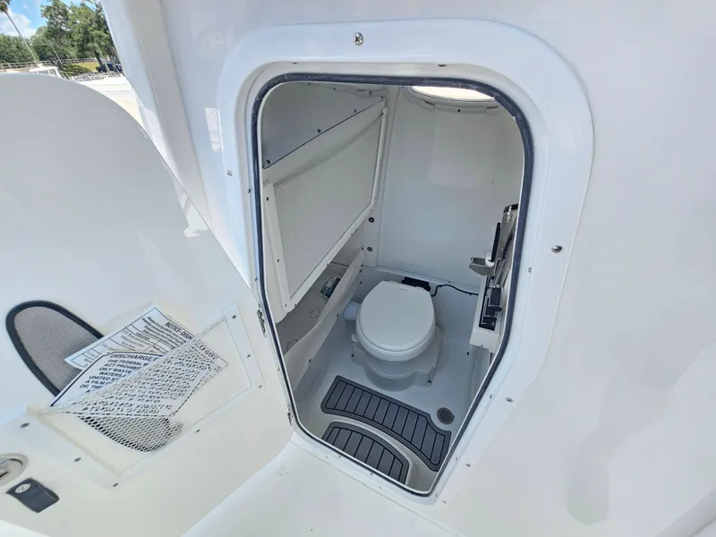 Slide: The Image of 2026 Sea Hunt Ultra 275 SE boat interior with compact marine toilet. - 30