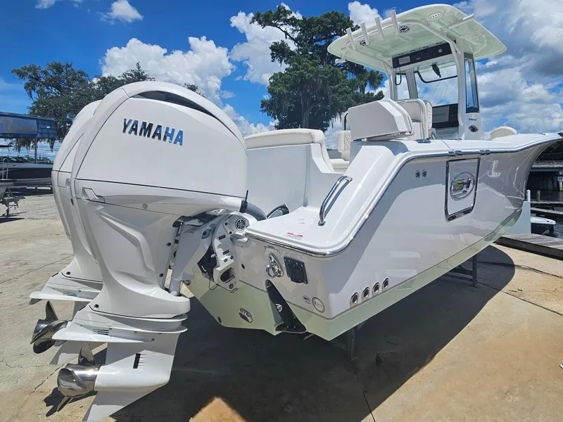 Slide: The Image of 2026 Sea Hunt Ultra 275 SE boat with Yamaha outboard engines, docked under a clear blue sky. - 4