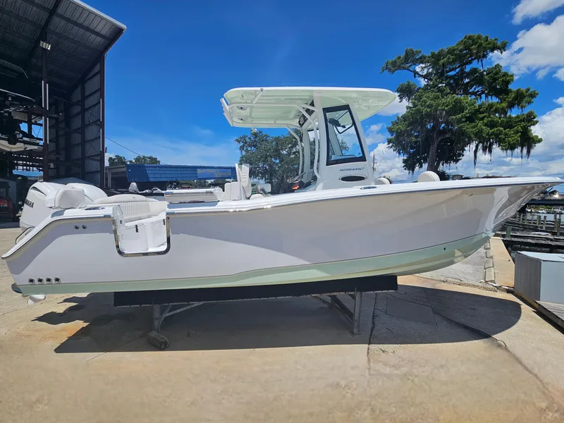 Slide: The Image of 2026 Sea Hunt Ultra 275 SE boat on display at a marina under a clear blue sky. - 7
