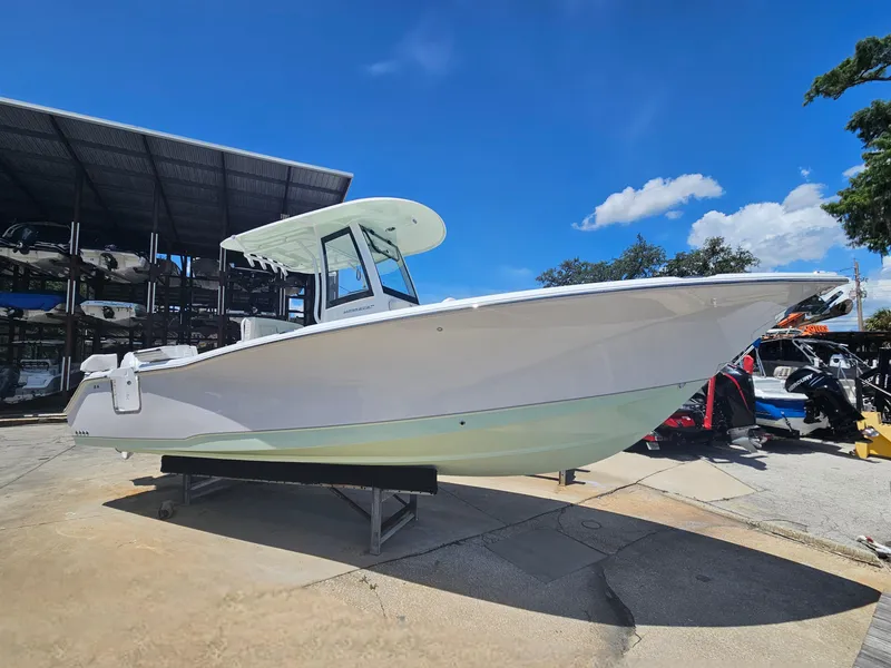Slide: The Image of 2026 Sea Hunt Ultra 275 SE boat displayed outdoors under clear blue sky. - 8