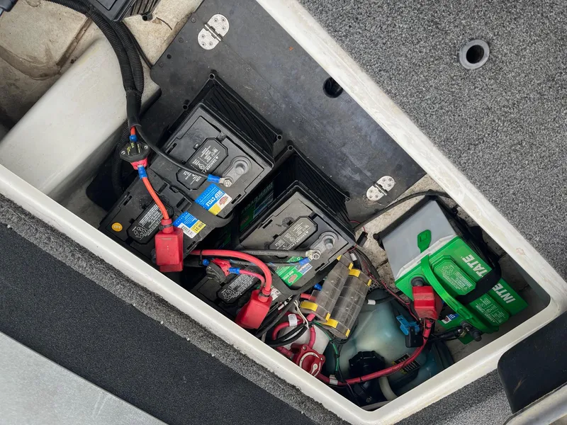 Slide: The Image of 2015 Nitro Z21 Z-Pro boat battery compartment with wiring and maintenance supplies. - 16
