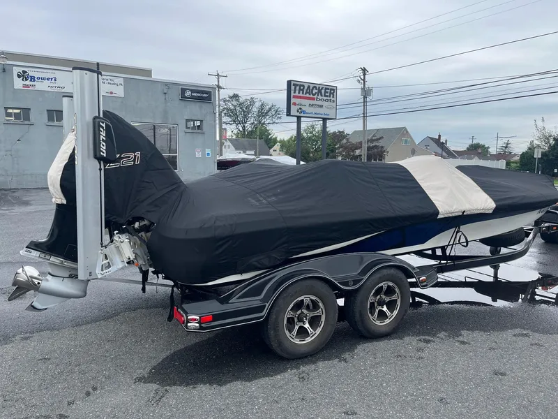 Slide: The Image of 2015 Nitro Z21 Z-Pro High Performance boat covered on trailer in parking lot. - 17