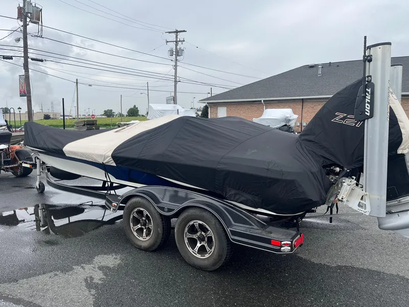 Slide: The Image of 2015 Nitro Z21 Z-Pro High Performance boat covered on trailer in parking lot. - 18