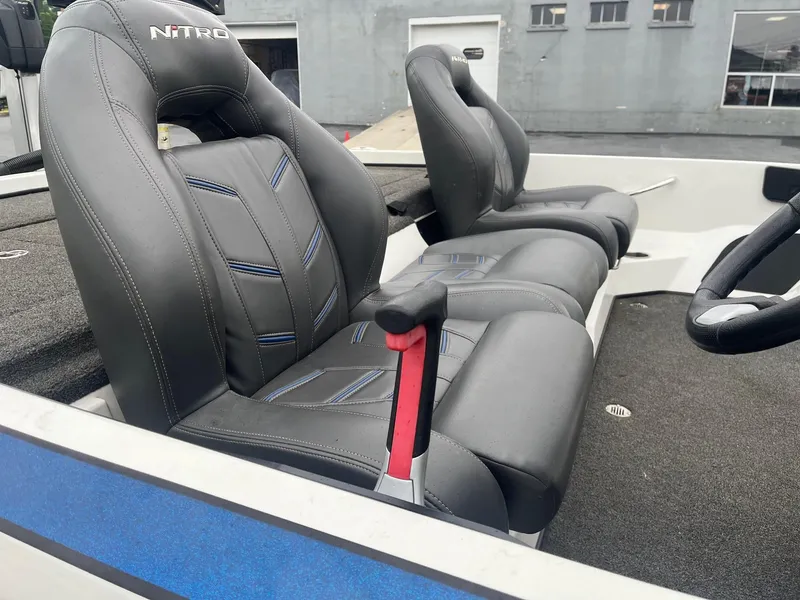 Slide: The Image of 2015 Nitro Z21 Z-Pro boat interior with black leather seats and steering wheel. - 4