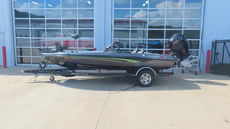 The Image of 2019 Ranger Z185 boat with trailer, parked outside a building with glass doors. - 1