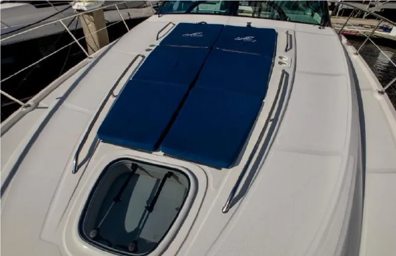 Slide: The Image of 2014 Sea Ray 470 Sundancer yacht deck with blue sun pads and hatch. - 10