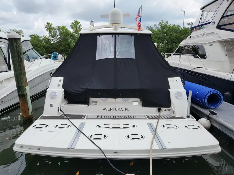 Slide: The Image of 2014 Sea Ray 470 Sundancer docked, rear view with black cover, Aventura, FL. - 12
