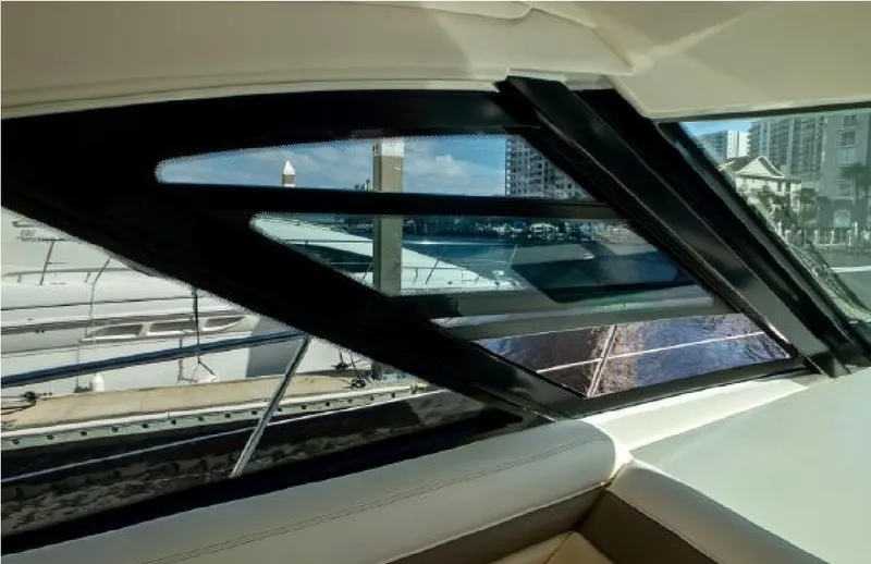 Slide: The Image of Interior view from a 2014 Sea Ray 470 Sundancer yacht, showcasing marina and cityscape. - 21