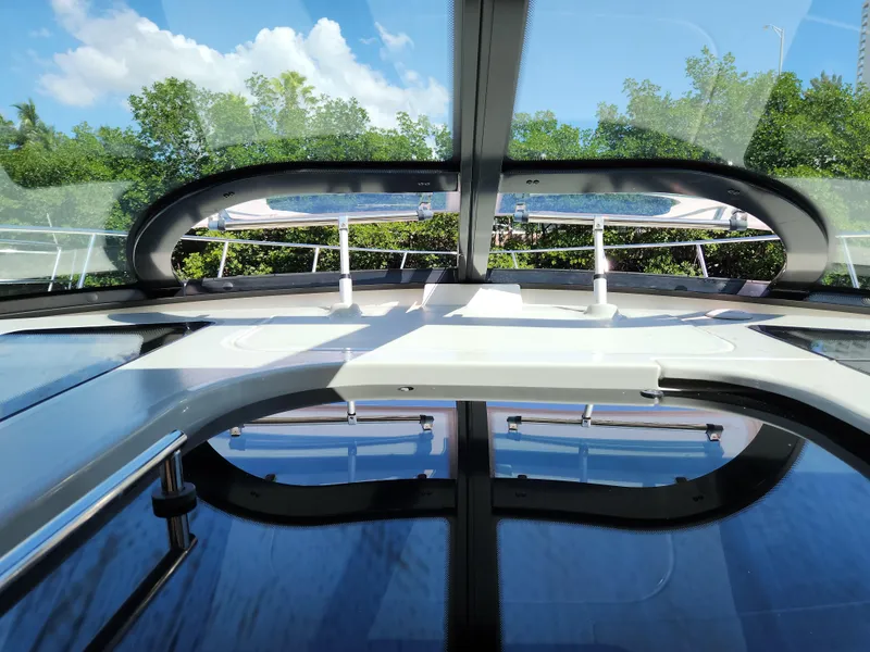Slide: The Image of 2014 Sea Ray 470 Sundancer yacht interior with panoramic sunroof and lush greenery outside. - 26