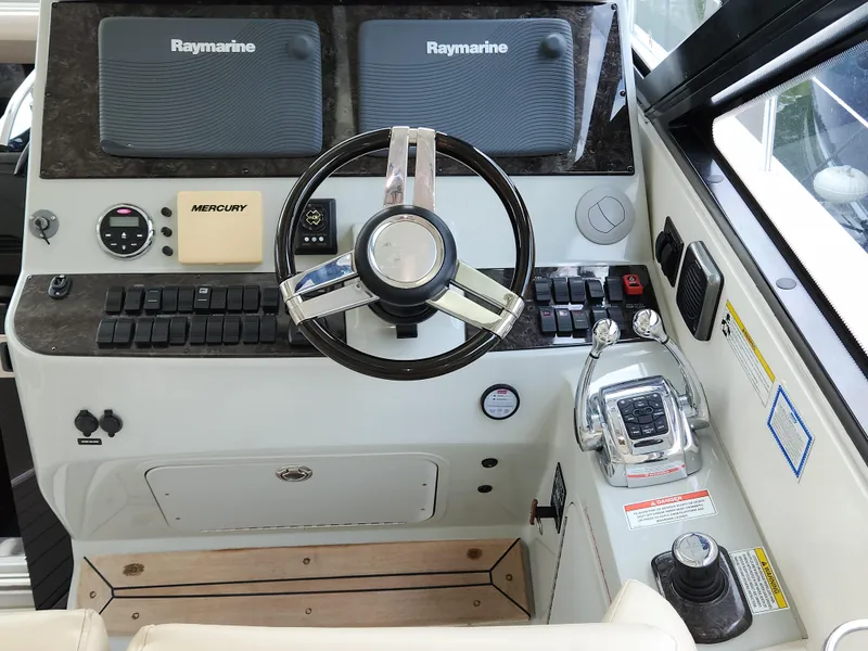Slide: The Image of Helm of 2014 Sea Ray 470 Sundancer with Raymarine displays and Mercury controls. - 29