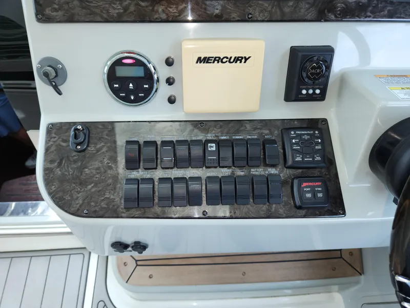 Slide: The Image of Control panel of a 2014 Sea Ray 470 Sundancer boat with Mercury system. - 33