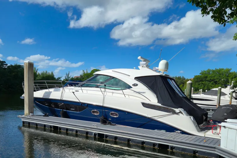Slide: The Image of 2014 Sea Ray 470 Sundancer yacht docked under a clear blue sky. - 4