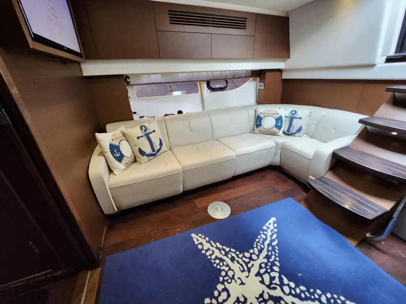 Slide: The Image of Luxurious interior of 2014 Sea Ray 470 Sundancer with plush seating and nautical decor. - 42