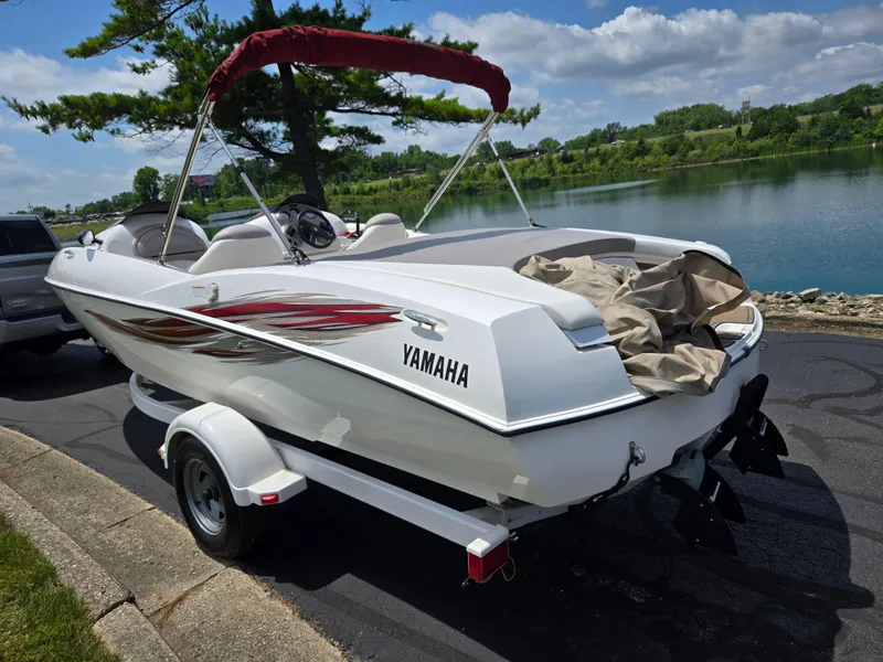 Slide: The Image of 2001 Yamaha LS 2000 boat on trailer by a scenic lake. - 1