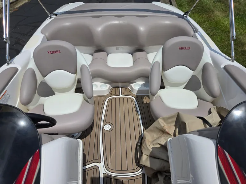 Slide: The Image of 2001 Yamaha LS 2000 boat interior with cushioned seating and wood-patterned flooring. - 19