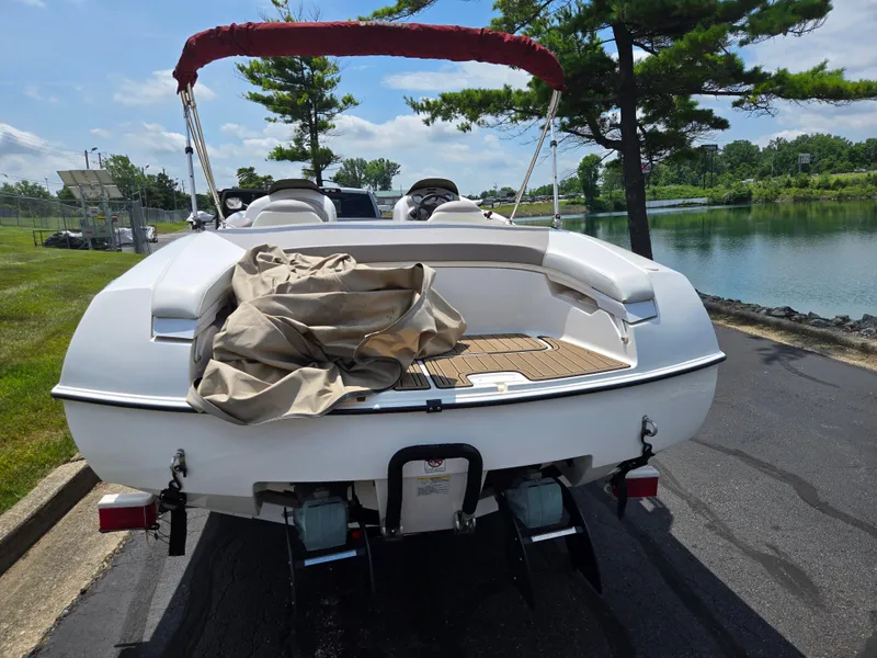Slide: The Image of 2001 Yamaha Boats LS 2000 on a sunny day by a lake, rear view. - 2