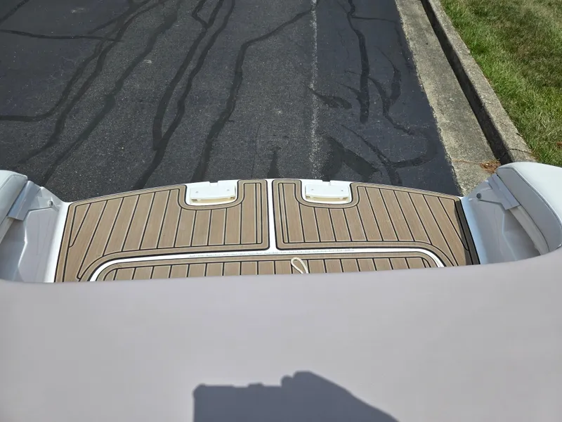 Slide: The Image of 2001 Yamaha Boats LS 2000 rear deck with wood-like finish, parked on asphalt. - 23