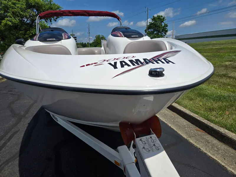 Slide: The Image of 2001 Yamaha LS 2000 boat on trailer, parked outdoors under a clear sky. - 6