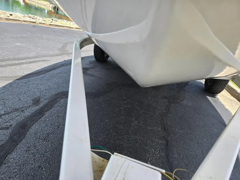 Slide: The Image of 2001 Yamaha LS 2000 boat on trailer, viewed from below, parked on asphalt. - 7