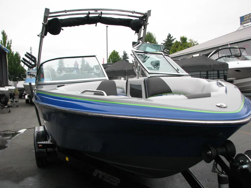 Slide: The Image of 2014 MB B-52 23 Widebody boat with blue exterior, parked on a trailer. - 2